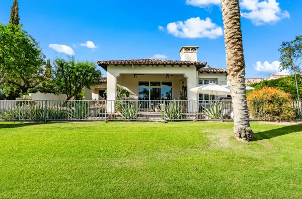 a view of a house with swimming pool and porch with furniture