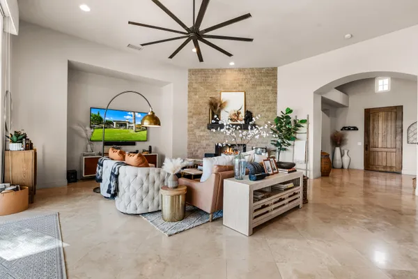 a living room with furniture and a potted plant