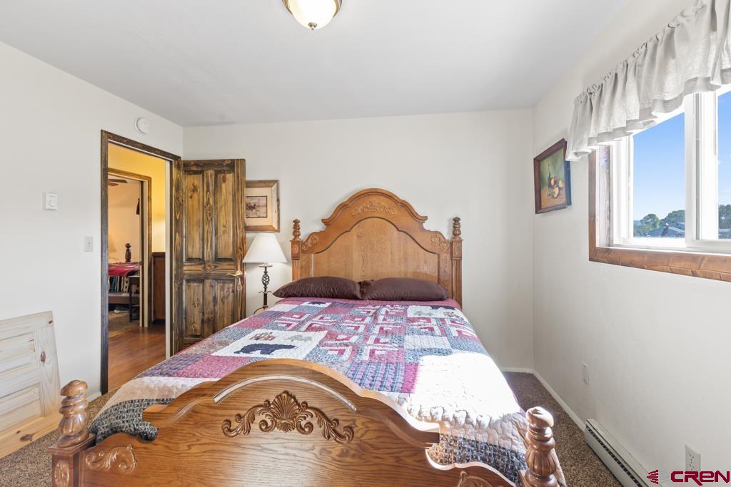 15567 6282nd Road Montrose, CO 81403 - Photo 13 of 36 a bedroom with a bed and a window