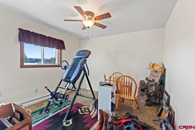 a bedroom with a bed a dresser and chair
