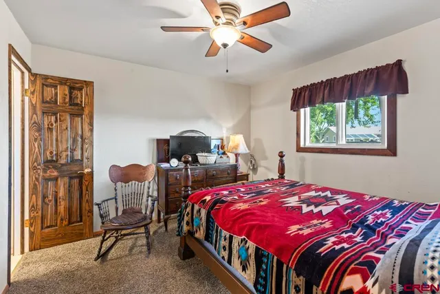 a bedroom with furniture and a chandelier