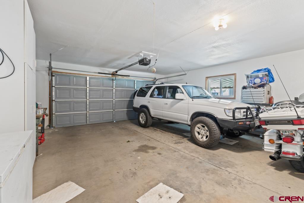 15567 6282nd Road Montrose, CO 81403 - Photo 20 of 36 a view of a garage with parked cars