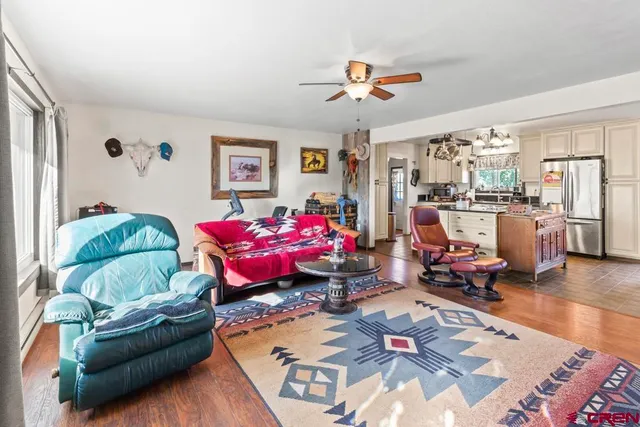 a living room with lots of furniture and wooden floor