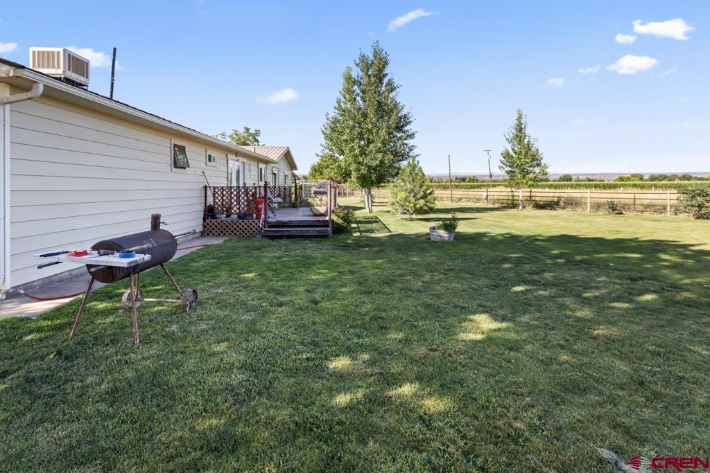 15567 6282nd Road Montrose, CO 81403 - Photo 23 of 36 a backyard of a house with table and chairs