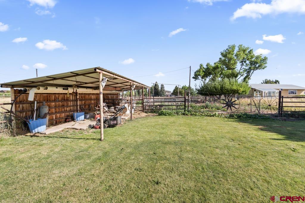 15567 6282nd Road Montrose, CO 81403 - Photo 24 of 36 a view of a house with backyard porch and sitting area
