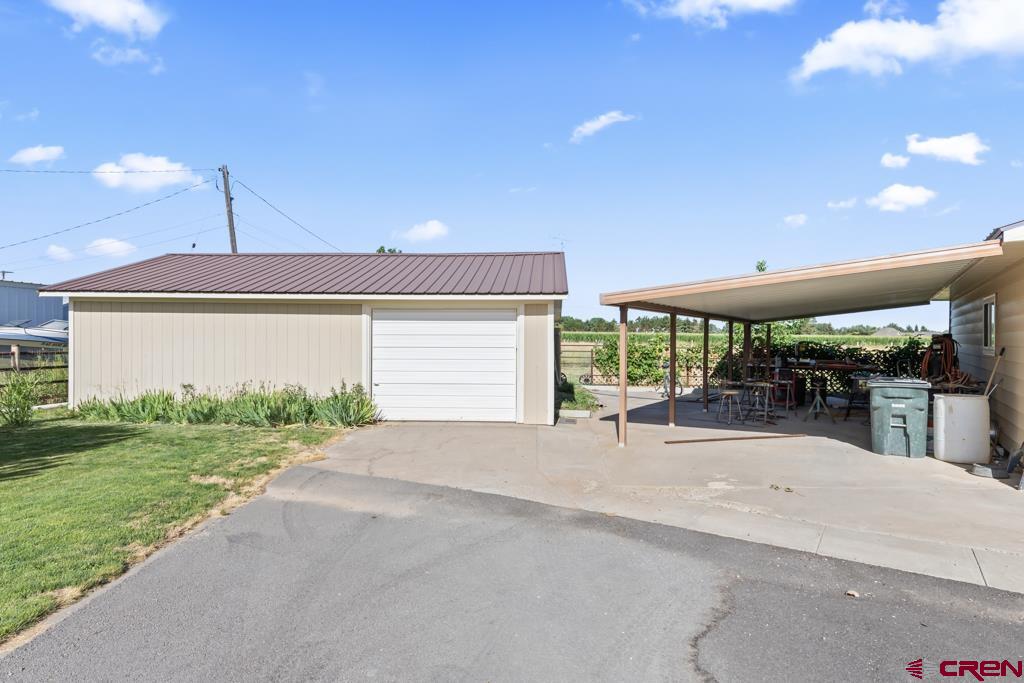 15567 6282nd Road Montrose, CO 81403 - Photo 31 of 36 a patio with a table and chairs and potted plants