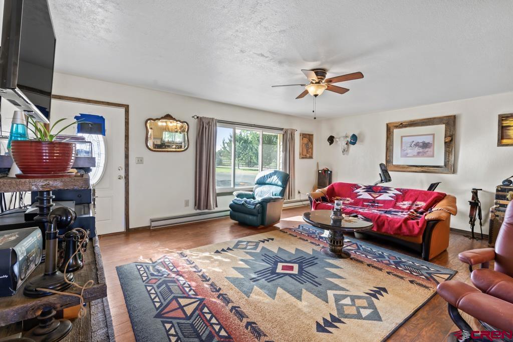 15567 6282nd Road Montrose, CO 81403 - Photo 4 of 36 a living room with furniture a flat screen tv and a window