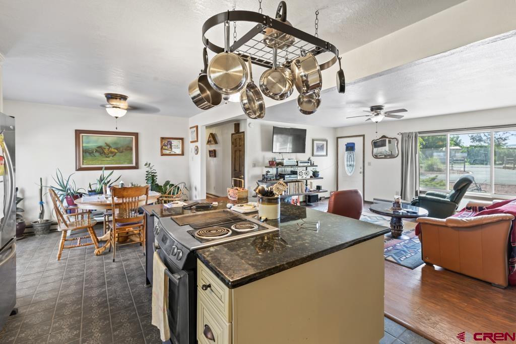15567 6282nd Road Montrose, CO 81403 - Photo 7 of 36 a group of people sitting in a living room