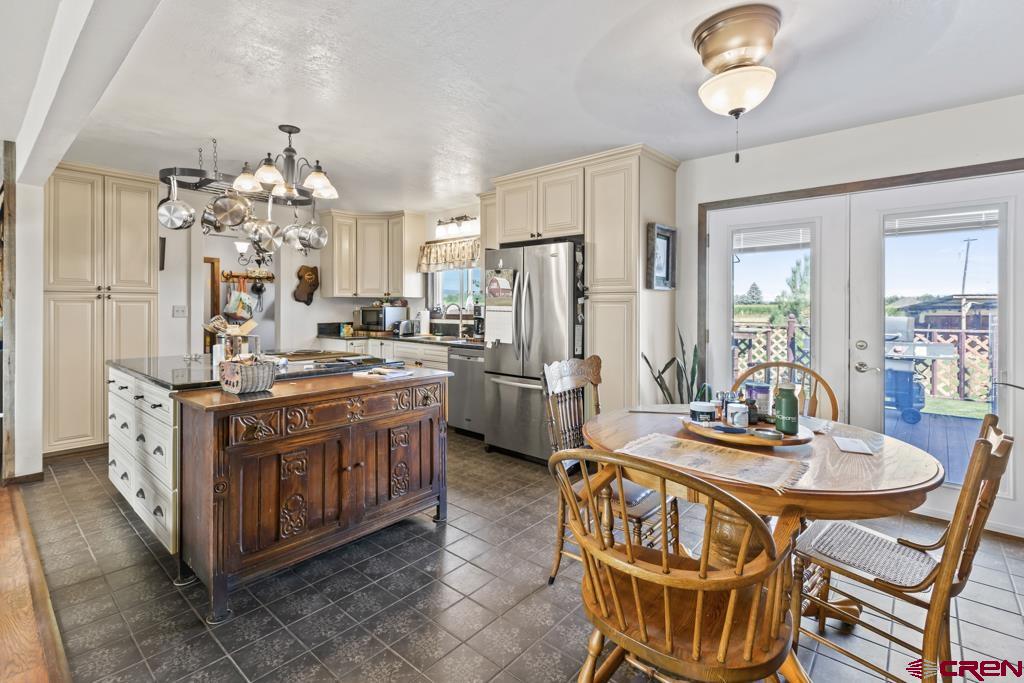 15567 6282nd Road Montrose, CO 81403 - Photo 9 of 36 a kitchen with stainless steel appliances a kitchen island hardwood floor and a sink