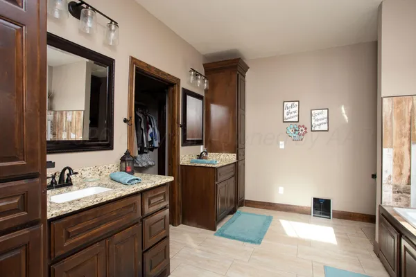 a spacious bathroom with a double vanity sink and a mirror