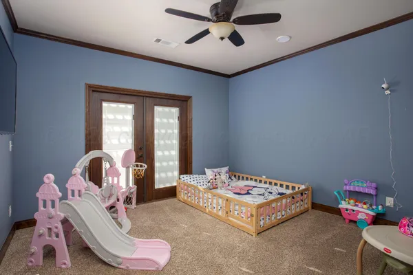 a bedroom with a bed and a chandelier