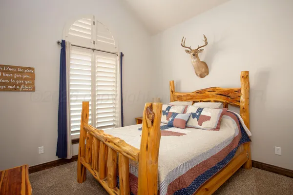 a bedroom with a bed and a table