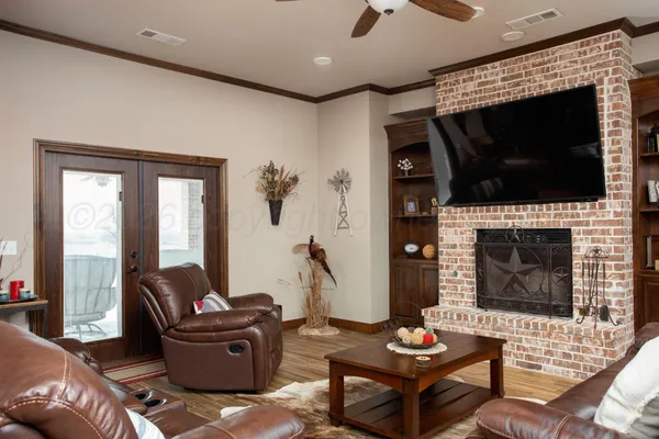 a living room with furniture a flat screen tv and a fireplace