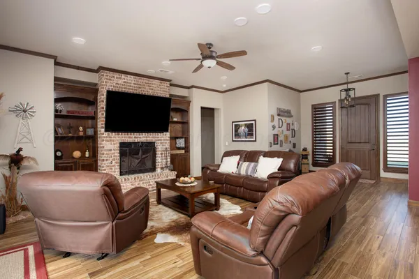 a living room with furniture a fireplace and a flat screen tv