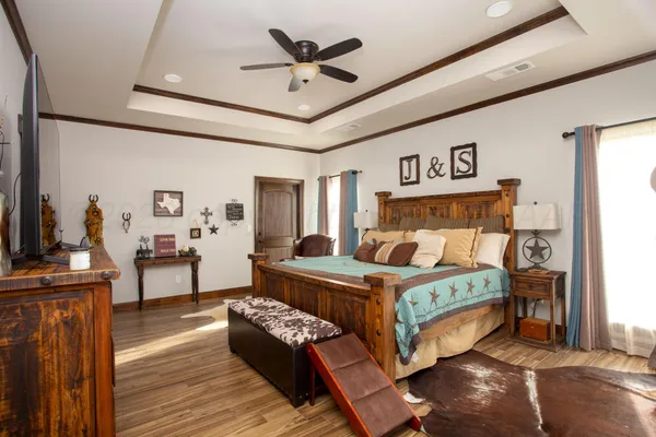 a bedroom with a bed and a chandelier