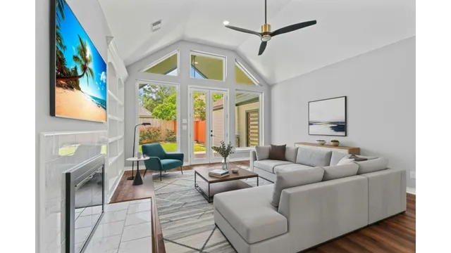a living room with furniture a fireplace and a flat screen tv