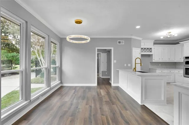 a kitchen with a wooden floor and a window