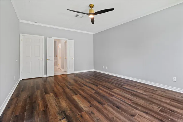 a view of empty room with wooden floor