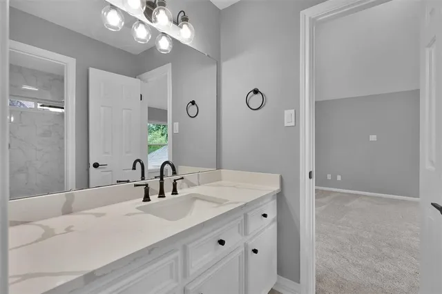 a bathroom with a sink vanity and a mirror