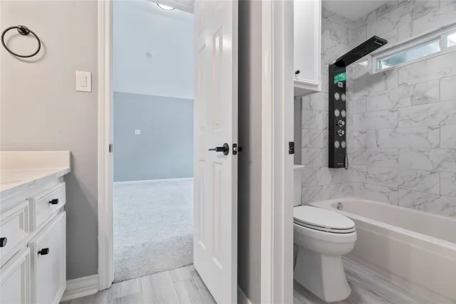 a bathroom with a toilet and a shower
