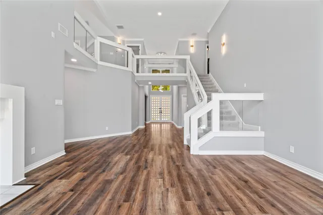 a view of entryway and hall with wooden floor