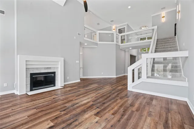 a view of a livingroom with wooden floor and a fireplace