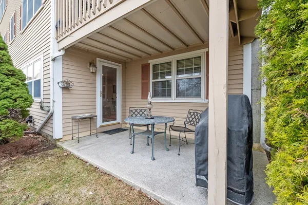 a view of a house with backyard and sitting area