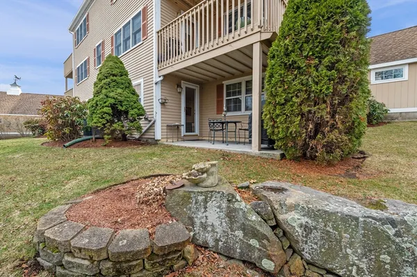 a view of a hallway with wooden floor and furniture