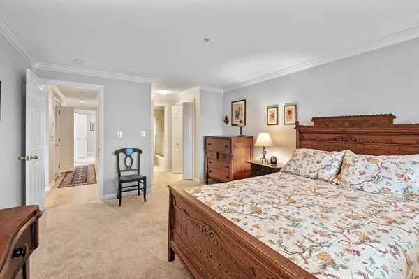 a view of a hallway with a livingroom and a bathroom with a sink