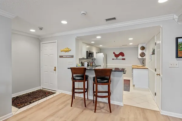 a view of dining room and livingroom with furniture wooden floor and a rug