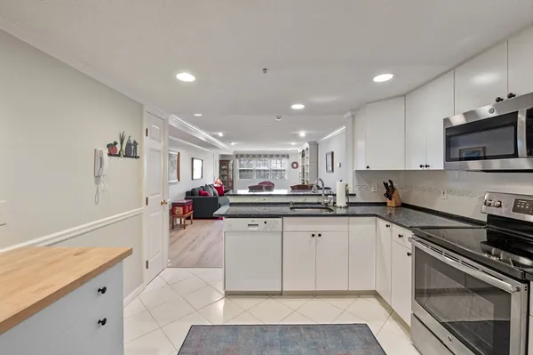 a kitchen with stainless steel appliances granite countertop a sink and cabinets