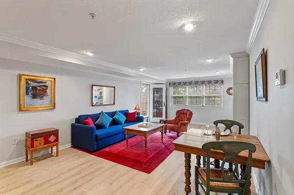 a living room with furniture a rug and a table