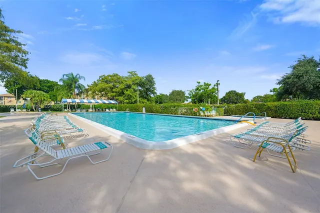 a view of a swimming pool with a yard