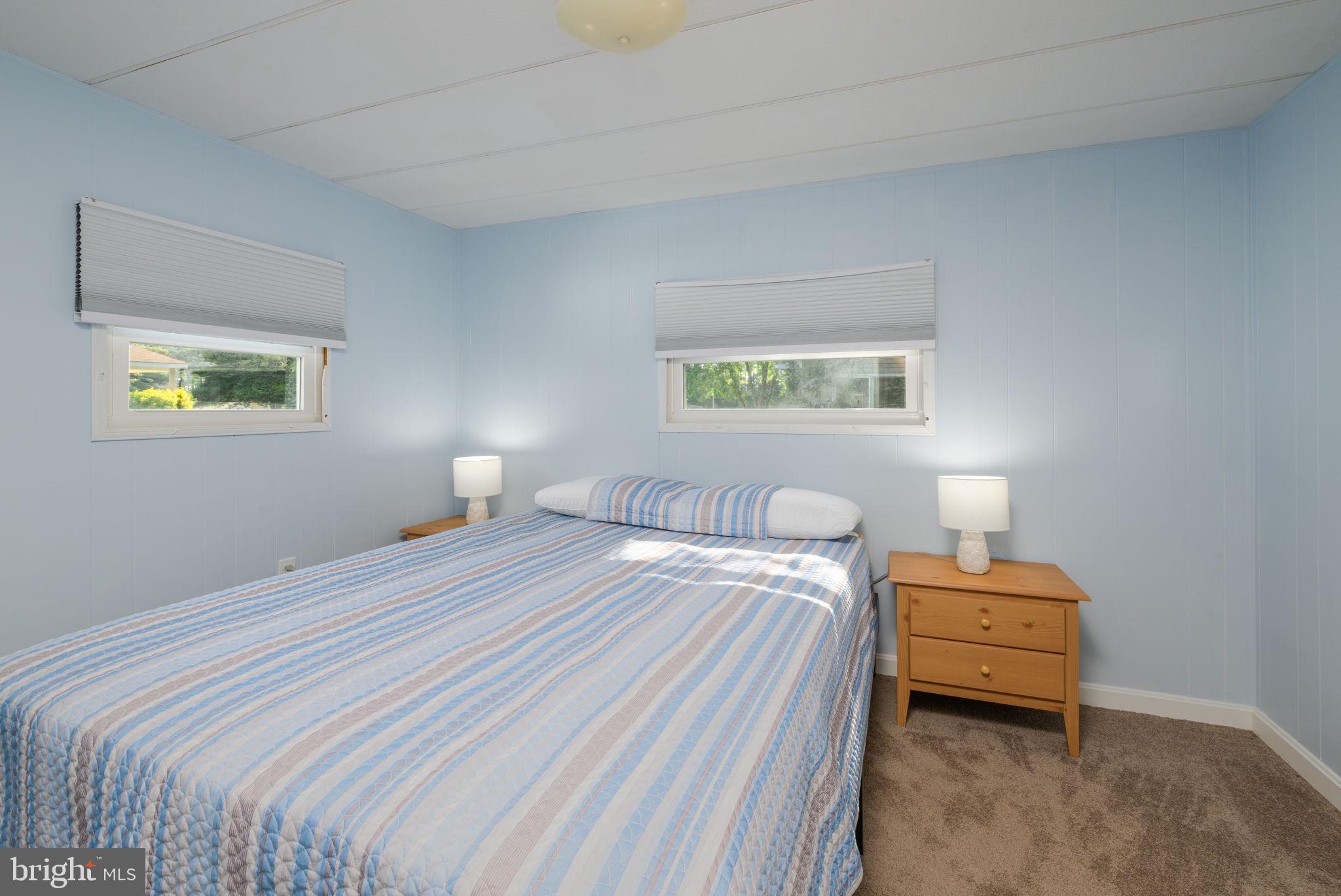 35401 Mallard Road Millsboro, DE 19966 - Photo 12 of 23 a bedroom with a bed and a lamp
