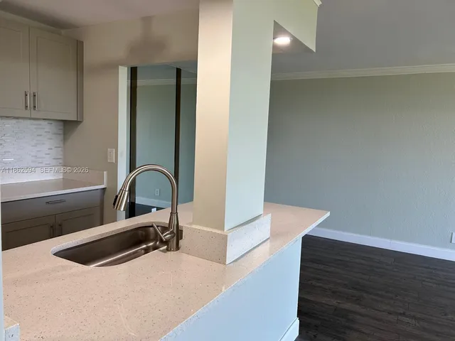 a view of kitchen with cabinets