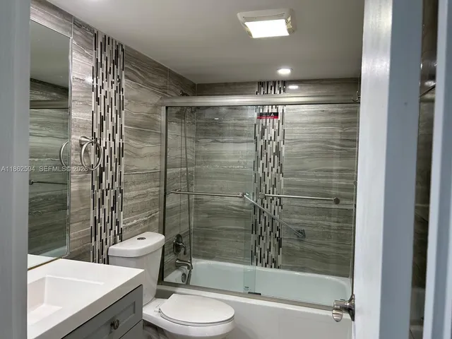 a bathroom with a glass shower door