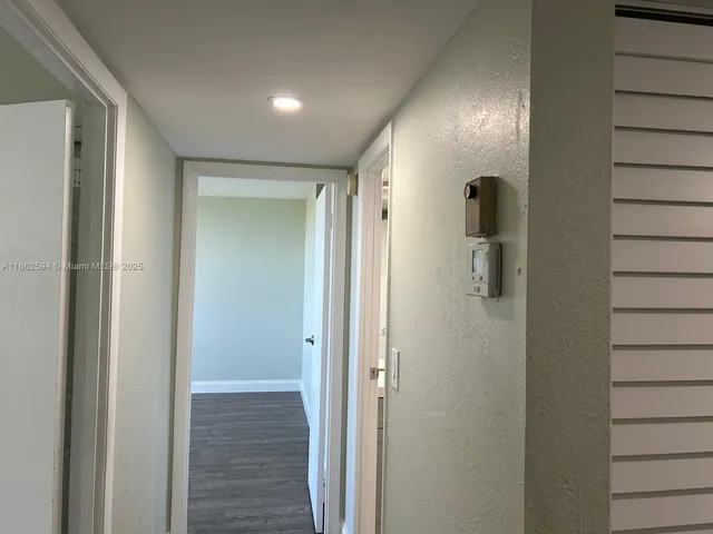 a view of kitchen cabinets and wooden floor