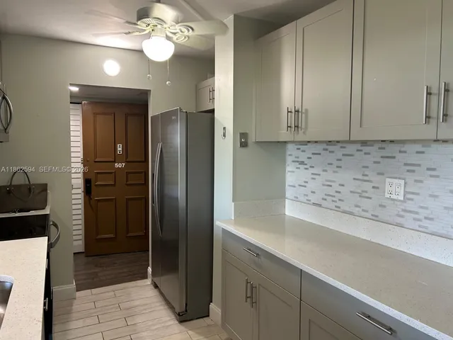 a view of kitchen cabinets and wooden floor