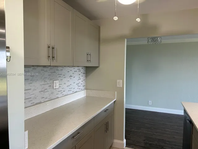 a kitchen with sink and refrigerator