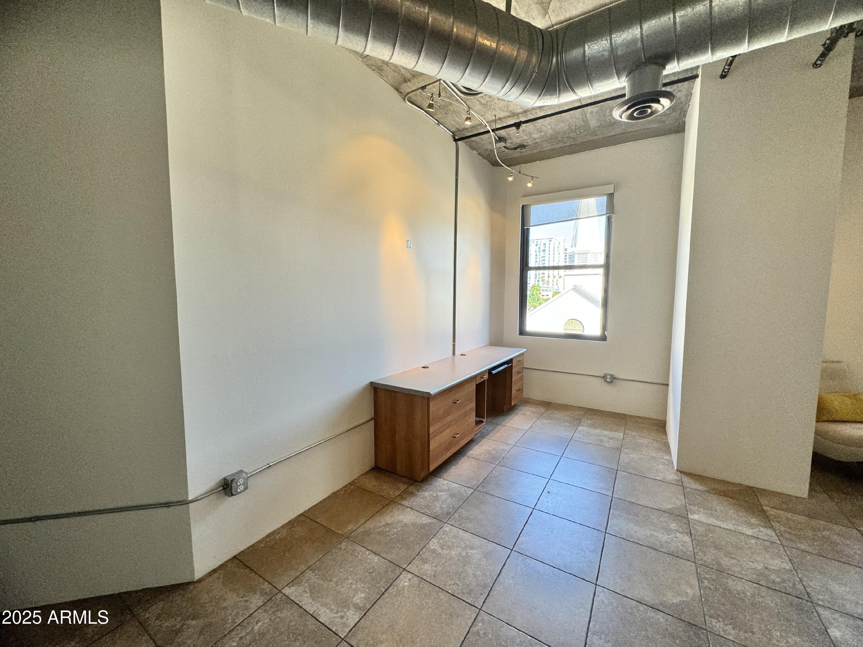 21 East 6th Street, Unit 306 Tempe, AZ 85281 - Photo 8 of 17 a room with a baby crib furniture and a window
