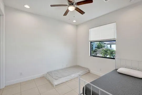 a view of room with window and ceiling fan