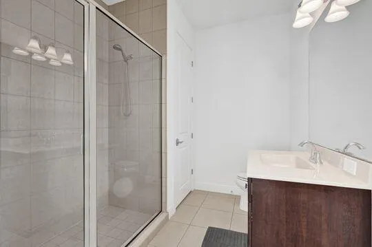 a bathroom with a sink mirror and shower