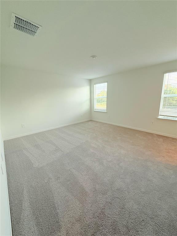 17602 Pleasantview Boulevard Land O Lakes, FL 34638 - Photo 12 of 27 an empty room with a window