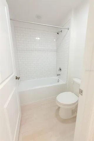 a bathroom with a toilet and a bathtub