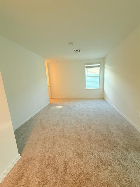 17602 Pleasantview Boulevard Land O Lakes, FL 34638 - Photo 14 of 27 an empty room with a natural light