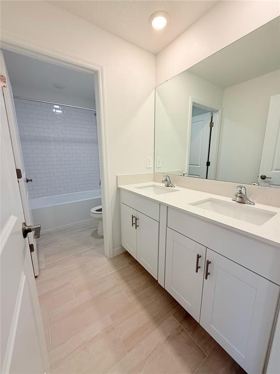 17602 Pleasantview Boulevard Land O Lakes, FL 34638 - Photo 17 of 27 a spacious bathroom with a double vanity sink a mirror and a shower