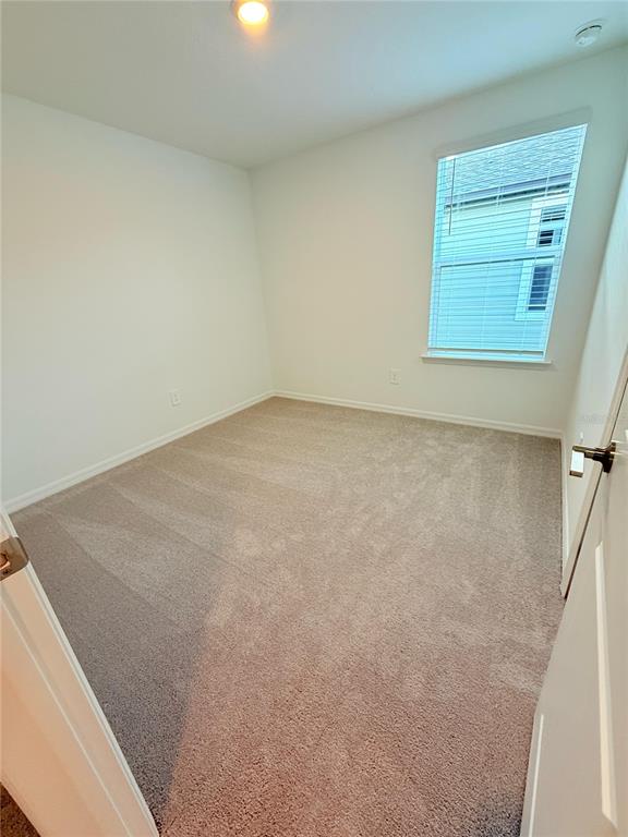 17602 Pleasantview Boulevard Land O Lakes, FL 34638 - Photo 20 of 27 a view of a small space with wooden floor and a window