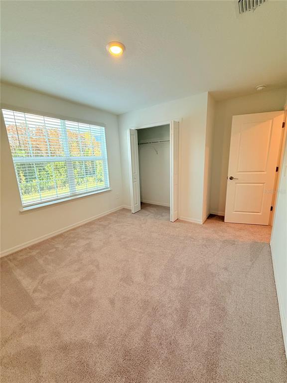 17602 Pleasantview Boulevard Land O Lakes, FL 34638 - Photo 22 of 27 an empty room with a window
