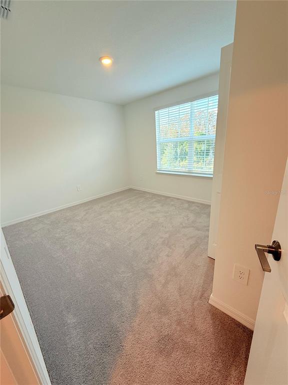 17602 Pleasantview Boulevard Land O Lakes, FL 34638 - Photo 24 of 27 an empty room with windows