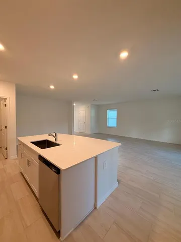 a kitchen with stainless steel appliances granite countertop a sink and a stove